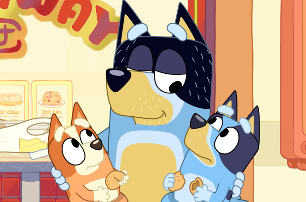 Dad shares a moment with Bingo and Bluey after reading the fortune cookie message