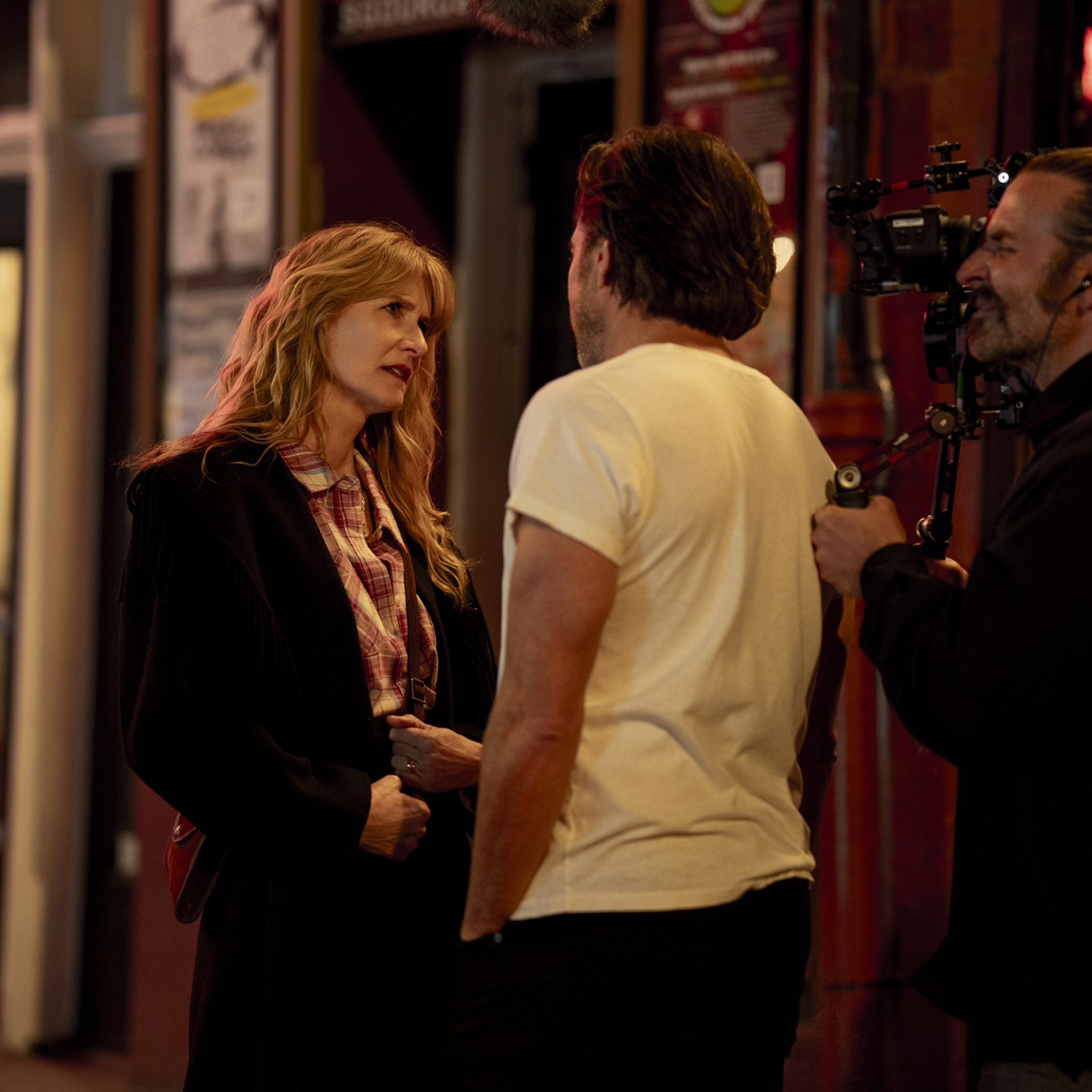 Laura Dern and Will Arnett with director Bradley Cooper on the set of IS THIS THING ON? Photo by Searchlight Pictures/Jason McDonald, Courtesy of Searchlight Pictures. © 2025 Searchlight Pictures All Rights Reserved.