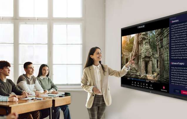 Large group of high school students listening to their teacher on a class in the classroom.
