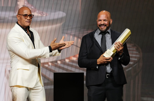 LAS VEGAS, NEVADA - JUNE 26: (L-R) Dwayne Johnson presents the UFC Hall of Fame trophy to Mark Kerr during the UFC Hall of Fame Class of 2025 Induction Ceremony at T-Mobile Arena on June 26, 2025 in Las Vegas, Nevada. (Photo by Jeff Bottari/Zuffa LLC)